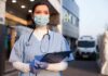 ER Chaos Sparks Miami Outrage Healthcare worker in scrubs wearing mask and gloves holding a clipboard