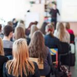 Students seated in a classroom listening to a presentation