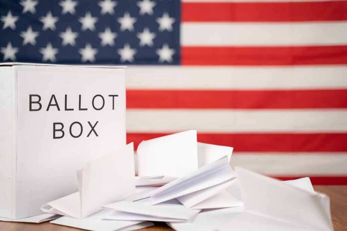Ballot box with papers in front of an American flag