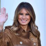 Melania’s Backdoor Diplomacy Stuns Moscow, Kyiv Melania Trump waving and smiling in a brown suede coat