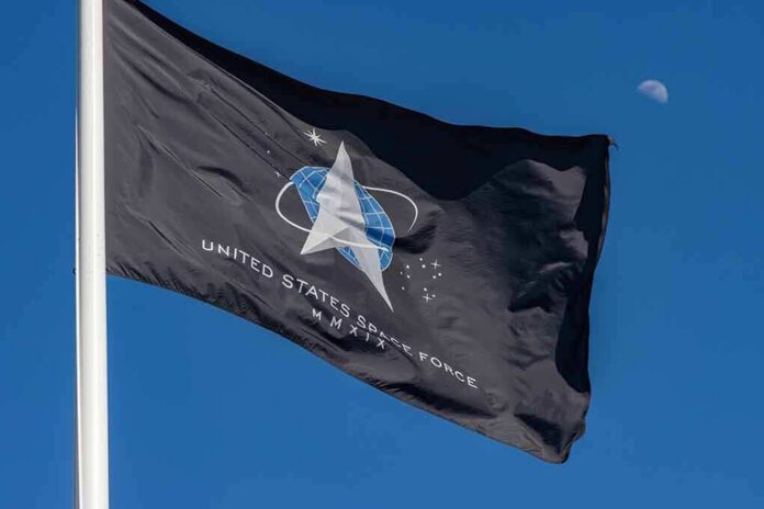 shutterstock_1921117997 United States Space Force flag waving against a blue sky