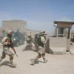 Nigeria’s Mega Rescue—Missing Arrests Raise Eyebrows Soldiers in desert uniforms run past a checkpoint amid dust