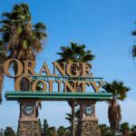 City Hall Firestorm: Mayor Under Review Orange County entrance sign with palm trees