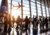Sanctions Shock: UAE Grounds Iranian Flights Passengers queue inside an airport terminal at sunset