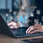 King’s Existential Warning Jolts AI Titans Hands typing on laptop with AI and tech icons overlay