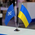 Missile Shortage Panic Grips Europe NATO and Ukraine table flags on a small metal stand