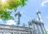 Industrial power plant with tall chimneys under blue sky