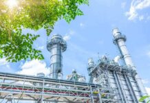 Iowa Steel Shock: $15B On The Line Industrial power plant with tall chimneys under blue sky