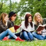 California’s Quiet Marriage Backdoor Exposed Group of young women reading books on grass in a park