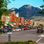 Café Clash Ignites National Firestorm small town main street with parked cars and mountain backdrop