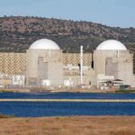 U.S.–Saudi Uranium Twist Sparks Arms Jitters Nuclear power plant with domed structures beside a water body and mountains in the background
