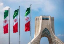 Hormuz Drama: Iran Maps A New Lane Iranian flags beside Azadi Tower in Tehran