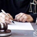 Voter Rolls Showdown: DOJ vs States Judge writing at desk with gavel and Lady Justice statue