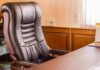 Leather office chair beside a wooden desk
