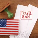 Visa Purge Looms — Asylum Backlash Brews US passport cover with travel documents and a travel ban stamp