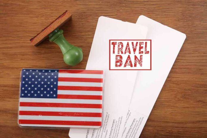 shutterstock_597730826 US passport cover with travel documents and a travel ban stamp