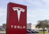 France Greenlights Tesla Road Trials Tesla dealership sign in front of parking lot