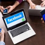 Judge Hammers Meta — Teen-Safety Uproar Laptop with Facebook on screen surrounded by smartphones