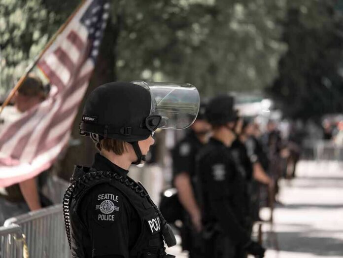 shutterstock_774295192 police officer in riot gear standing in a line