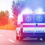 Truck Invades Youth Field – Chaos Erupts Ambulance van with flashing lights on a rural road