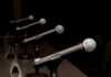Brazil Debate Erupts Over Corruption Allegations Row of microphones on stands at a panel table