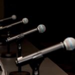Brazil Debate Erupts Over Corruption Allegations Row of microphones on stands at a panel table