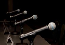 Brazil Debate Erupts Over Corruption Allegations Row of microphones on stands at a panel table