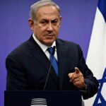 Election Shock: Trump Backs Netanyahu man in suit speaking at a podium with an Israeli flag