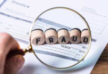 Mayor Nabbed In COVID Grant Scandal Magnifying glass highlighting wooden blocks spelling fraud on an invoice