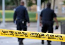 Brutal Case Ignites Japan – US Showdown Police officers walking past caution tape at a crime scene