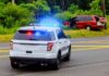 Highway Horror Halted by Soldiers Police SUV with flashing lights at roadside crash scene