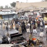 Drone Inferno Guts Crowded Market Crowd gathers at a market after a vehicle explosion