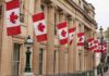 Church Arson Showdown Ignites Ottawa Canadian flags on a neoclassical building facade