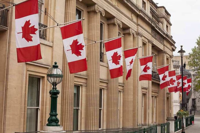shutterstock_1232918848-1 Canadian flags on a neoclassical building facade