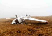Dog-Laden Plane Stops Inches From Doom Crashed airplane lying on its side in a foggy field