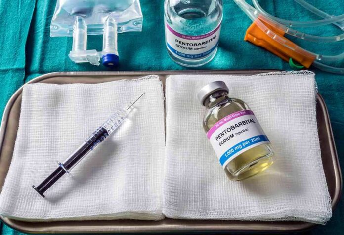 shutterstock_1367049818 Medical tray with syringe and pentobarbital vials on gauze