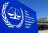 White House HITS ICC – Judges Targeted International Criminal Court sign with scales emblem outside modern building