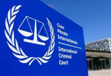 International Criminal Court sign with scales emblem outside modern building