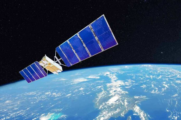 shutterstock_1680161074 Satellite with blue solar panels orbiting Earth