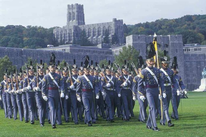 shutterstock_177027197 Cadets in gray uniforms march in formation on a campus lawn