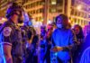 Historic City Hall TORCHED – France Erupts Protesters talk with police officers at night in city street