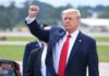 GOP Scramble In Deep-Red Kansas man in suit raising a clenched fist outdoors