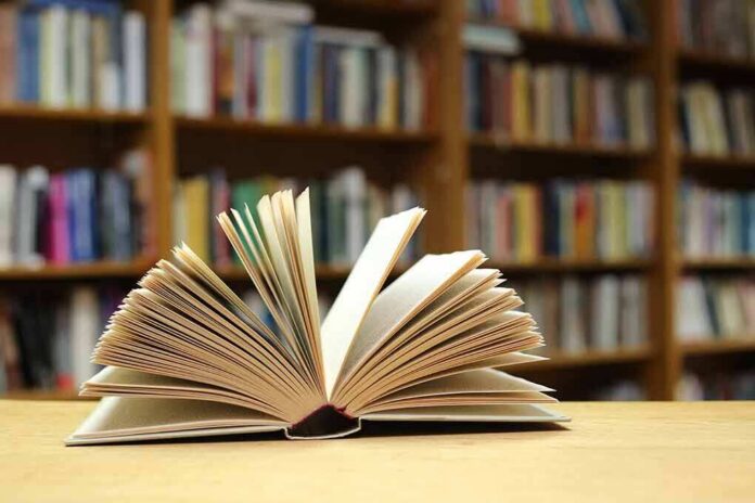 shutterstock_1889457781 Open book on a table in a library