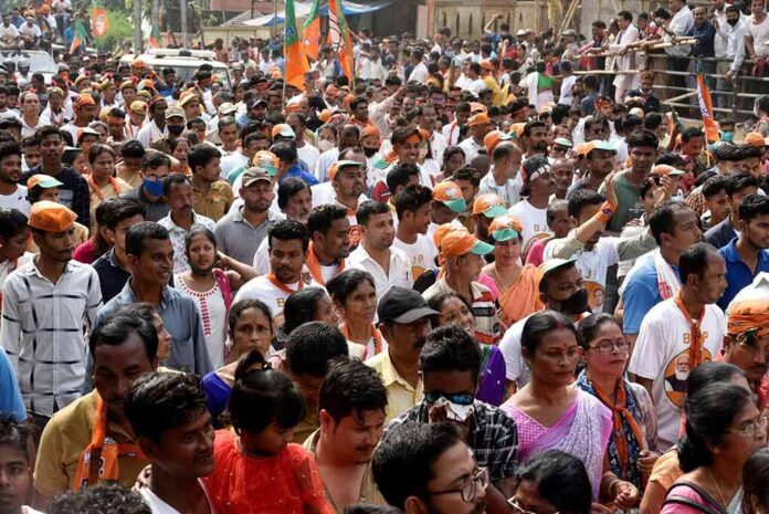 shutterstock_1939414339-1 Crowd at a political rally with Kumar Gandharva, Ritu Rani, Jersson Vásquez, Mamata Banerjee, Pravin Amre, Sumrai Tete, Rangana Herath, and Gerson Torres
