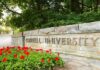 Cornell Frats Frozen After Chilling Allegations Cornell University stone entrance sign with red flowers