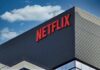Layoff Wave Hits Netflix’s Core Teams Netflix logo on modern office building exterior