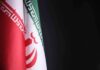 Unannounced Air-Base Meeting Rattles Iran Watchers Iran flag close-up on dark background