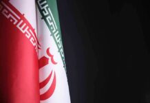Iran flag close-up on dark background