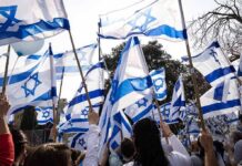 Election Chaos Upends Middle East Calculus Crowd waving Israeli flags outdoors