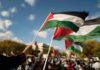 Palestinian Ballots Pushed To 2027 Palestinian flags waving at an outdoor rally